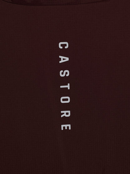 Close-up of a dark brown ribbed fabric with the word 'CASTORE' printed vertically in white capital letters.