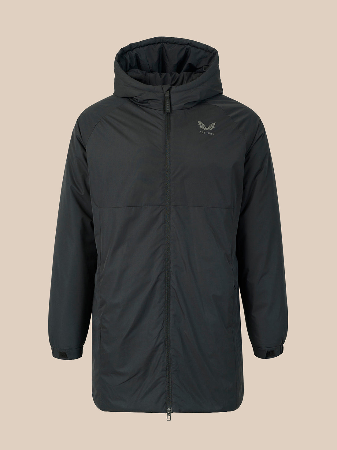 A dark gray hooded jacket with a full front zipper and a small winged logo on the left chest, displayed against a solid beige background.
