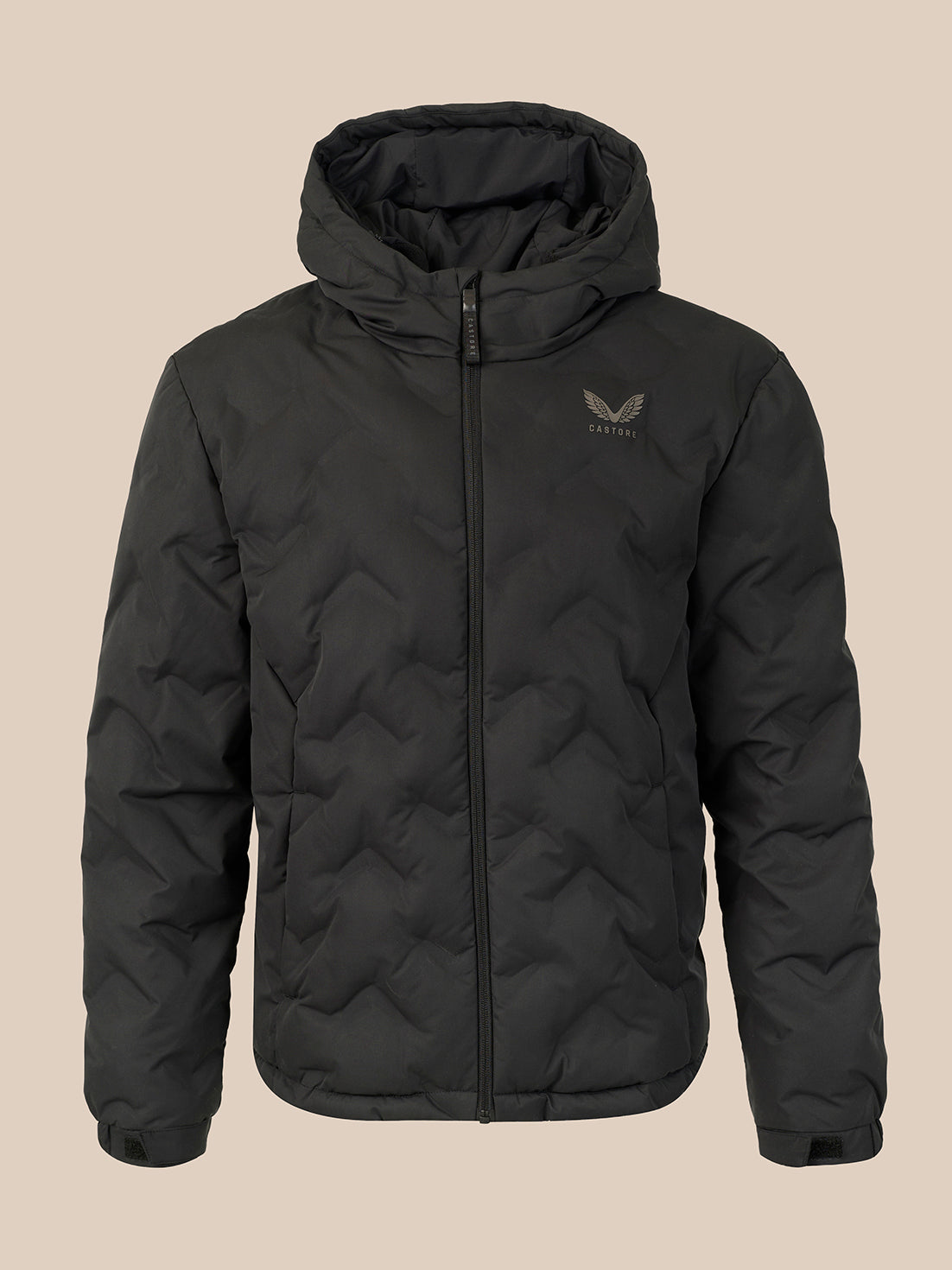 A black hooded puffer jacket with a full-zip front and a small gray wing logo on the left chest, displayed against a solid beige background.