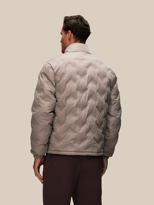 Back view of a man wearing a taupe padded quilted jacket