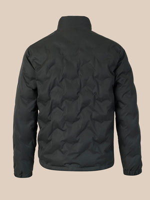 A dark gray quilted puffer jacket shown from the back, featuring a high collar and a wavy quilted pattern, set against a solid beige background.