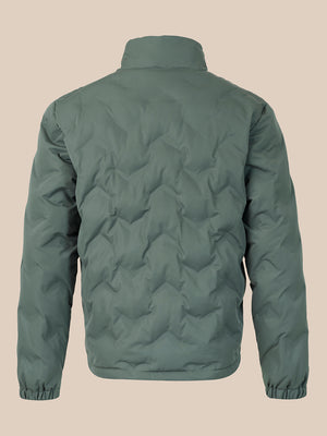 A sage green quilted puffer jacket shown from the back, featuring a stand-up collar, elasticized cuffs, and a wavy diamond quilting pattern, set against a solid beige background.