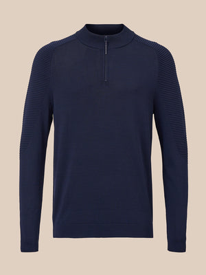 A navy blue long-sleeve quarter-zip sweater with textured ribbed shoulder and sleeve panels, displayed on a neutral beige background.