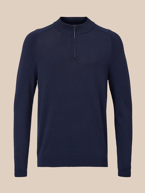 A navy blue long-sleeve quarter-zip sweater with textured ribbed shoulder and sleeve panels, displayed on a neutral beige background.