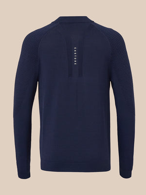 A navy blue long-sleeve knit sweater with textured ribbed shoulder panels and a vertical zippered placket featuring the brand name 'CASTORE' in white, shown against a solid beige background.