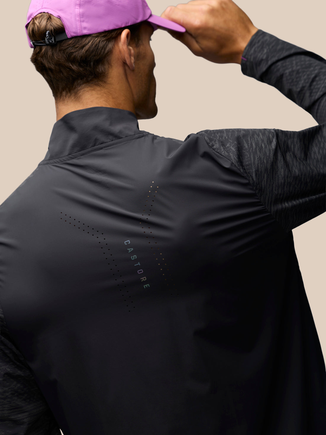 Back view of black Zone Long Sleeve 1/4 Zip Top with perforated back panel and reflective piping