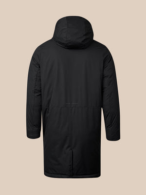 A black hooded winter jacket shown from the back, photographed on a plain beige studio background.