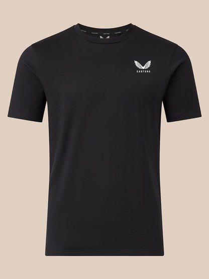 A black short-sleeve crewneck t-shirt with a small white winged logo and the word 'CASTORE' printed on the left chest, displayed against a solid beige background.