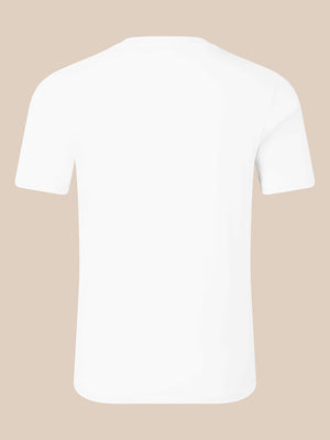 A plain white short-sleeve crewneck t-shirt shown from the back, centered on a solid light beige background.
