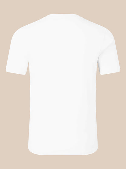 A plain white short-sleeve crewneck t-shirt shown from the back, centered on a solid light beige background.