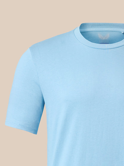 A light blue short-sleeve crewneck t-shirt shown on a mannequin torso against a solid beige background.