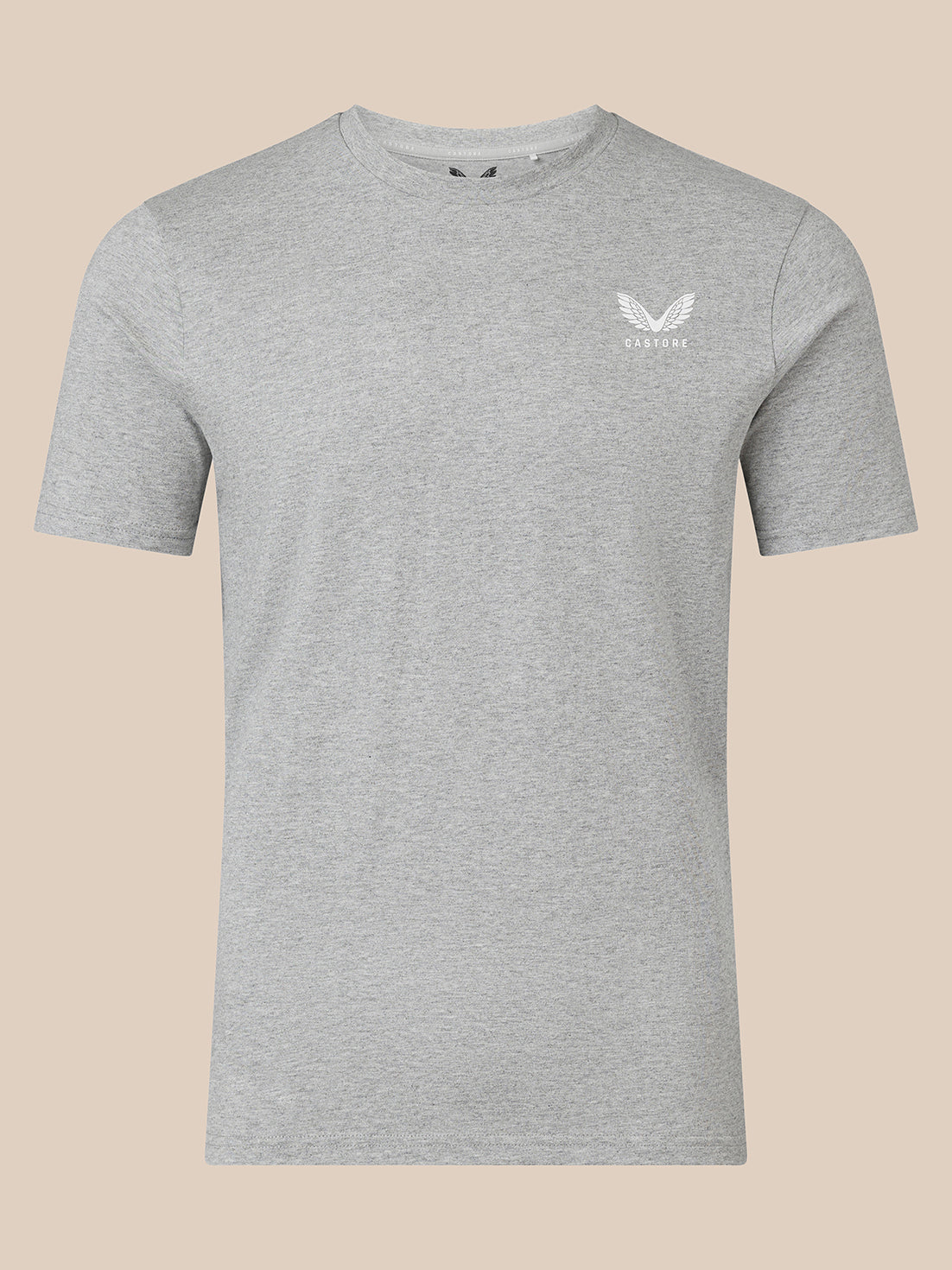 A light gray heather crewneck t-shirt with a small white winged logo on the left chest, displayed on a solid beige background.