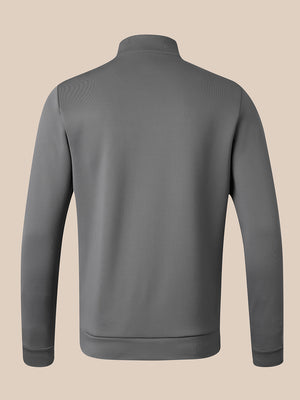 A dark gray long-sleeve quarter-zip pullover jacket shown from the back, featuring a mock neck and ribbed cuffs and hem, set against a solid beige background.