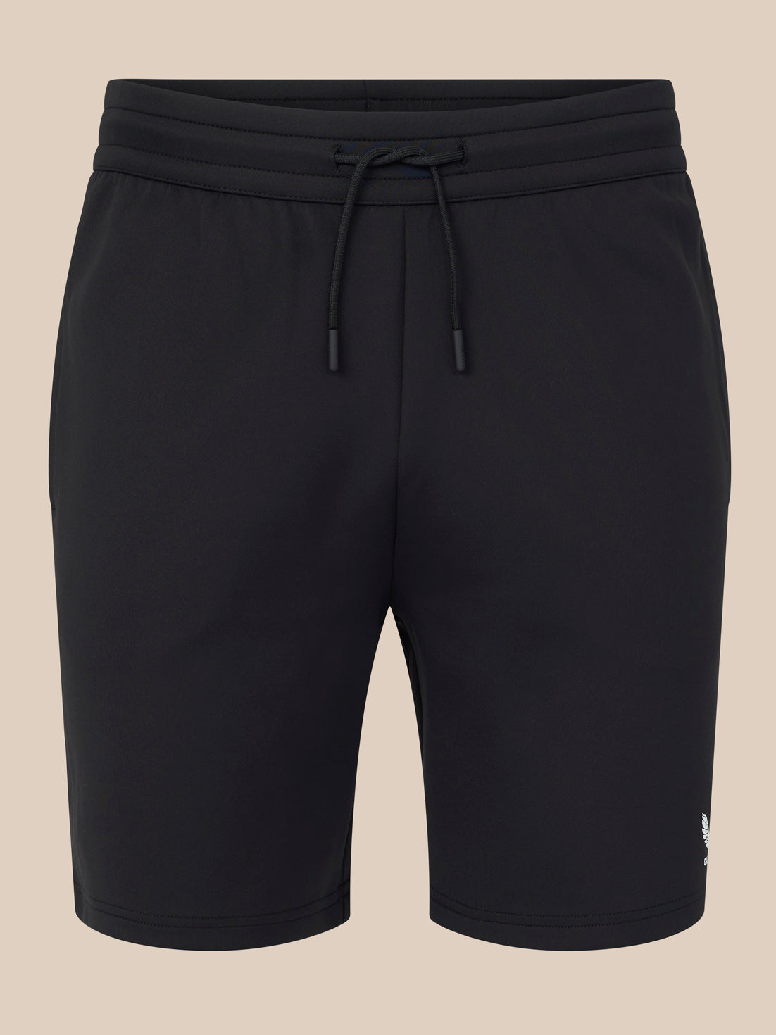 Black shorts with a drawstring on a beige background