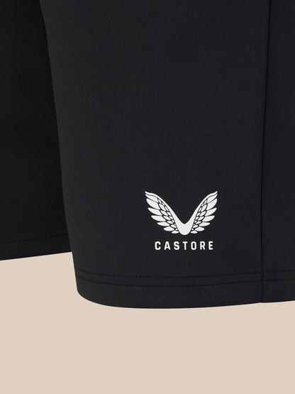 Black shorts with a white logo and text on a beige background