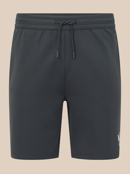 Dark gray shorts with a drawstring on a beige background