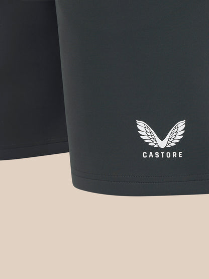 Black shorts with a white logo on a beige background