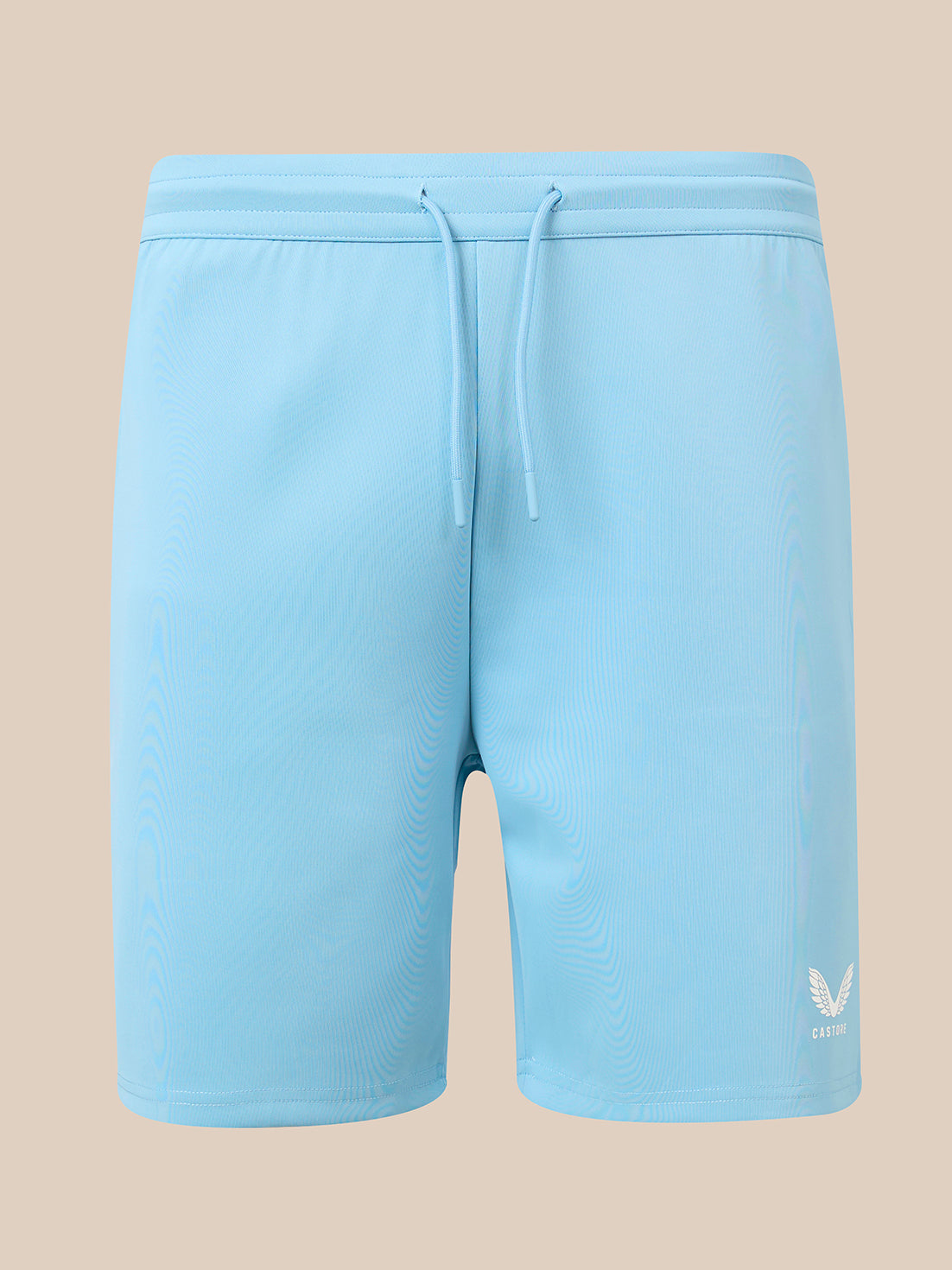 Light blue athletic shorts with a drawstring waist and a small white wing logo on the lower left leg, shown against a solid beige background.