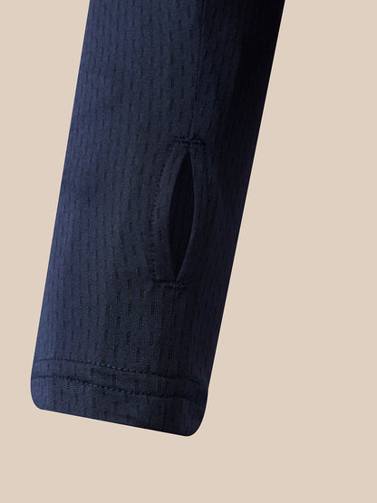 Close-up of a dark navy textured sleeve with a vertical slit detail, set against a solid beige background.