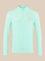 A light mint green long-sleeve athletic quarter-zip pullover with a small white logo on the left chest, displayed on a solid beige background.