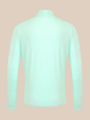 A long-sleeve high-neck top shown from the back, in a very pale mint green color, displayed on a solid beige background.
