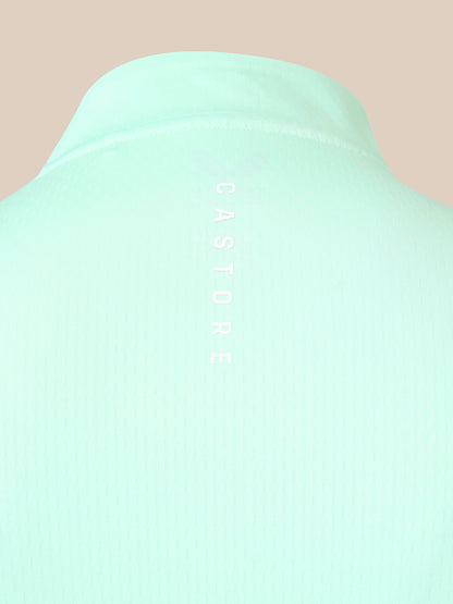 Close-up of a mint green ribbed knit garment, likely a sweater or knit top, showing the back collar and vertical 'CASTORE' branding printed in white on the center.