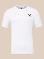 A white short-sleeve athletic t-shirt with a black winged logo and the word 'CASTORE' printed on the left chest, displayed against a solid beige background.