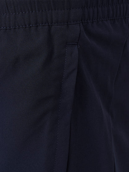 Close-up of dark navy fabric with an elastic waistband and a vertical seam detail.