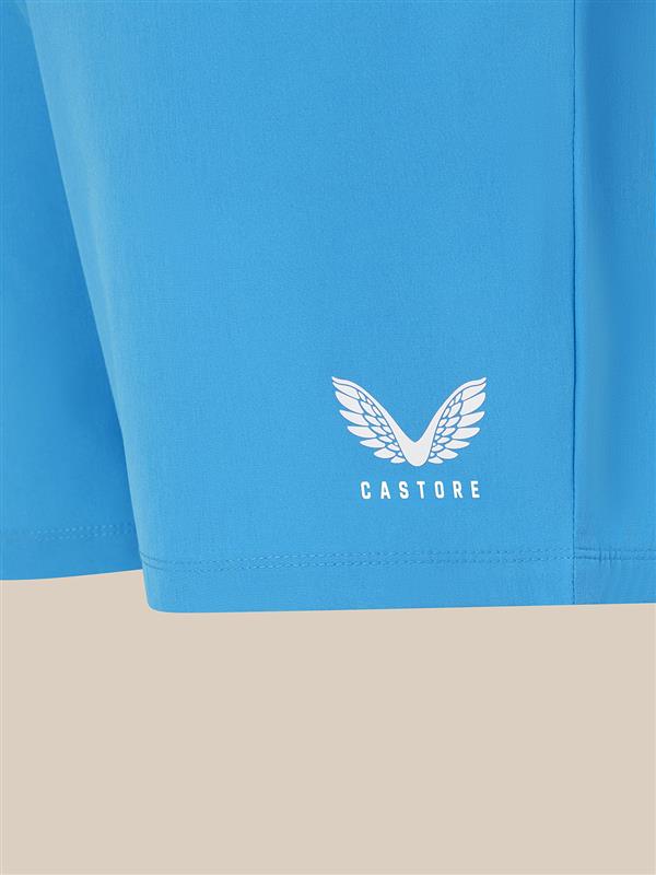 Blue shorts with a white logo and text on a beige background