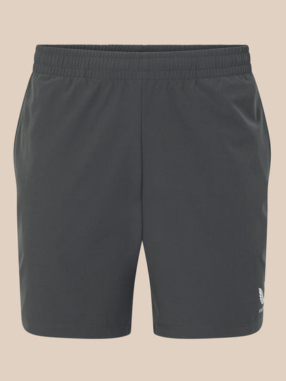 Dark gray shorts with a brand logo on a beige background