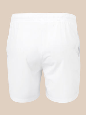 White athletic shorts with an elastic waistband, shown from the back on a solid beige background.