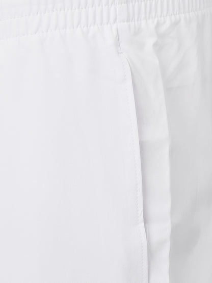 Close-up of white fabric with an elastic waistband and side seam detail.