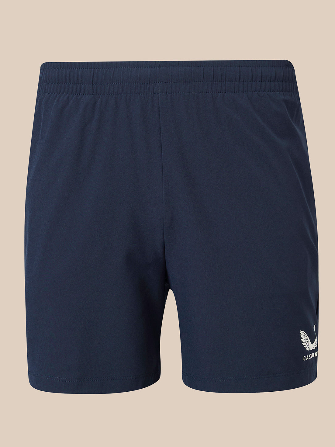 Navy blue athletic shorts with an elastic waistband and a small white winged logo on the lower left leg, displayed against a solid beige background.