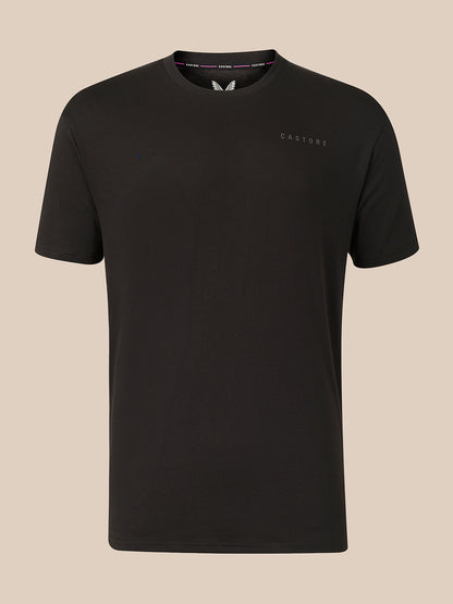 A black short-sleeve crewneck t-shirt with a small tonal 'CASTORE' logo on the left chest, displayed against a solid beige background.