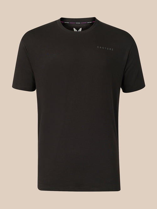 A black short-sleeve crewneck t-shirt with a small tonal 'CASTORE' logo on the left chest, displayed against a solid beige background.