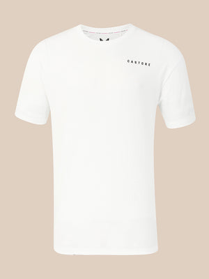 A white short-sleeve crewneck t-shirt with 'CASTORE' printed in small black letters on the left chest, displayed against a solid beige background.