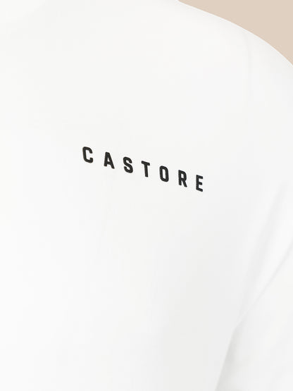 Close-up of a white garment with the word 'CASTORE' printed in black across the chest.