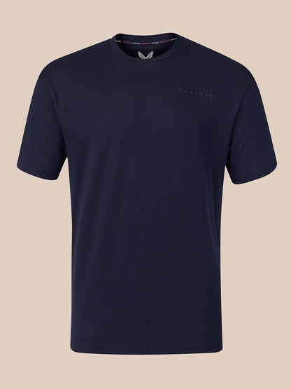 A dark navy blue crew-neck t-shirt with a subtle tonal embroidered logo on the left chest, displayed against a solid beige background.