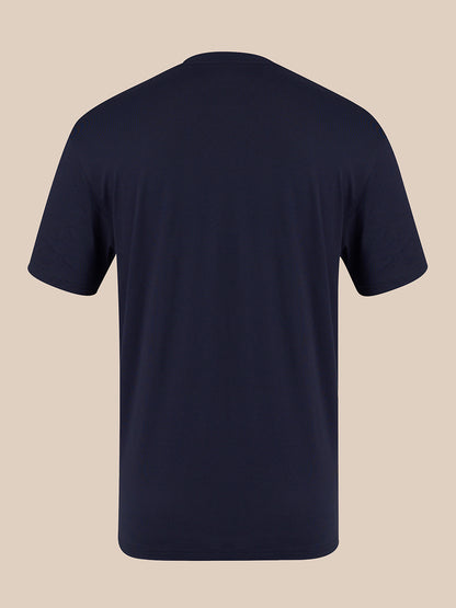 A dark navy blue short-sleeve crewneck t-shirt shown from the back, displayed on a solid beige background.