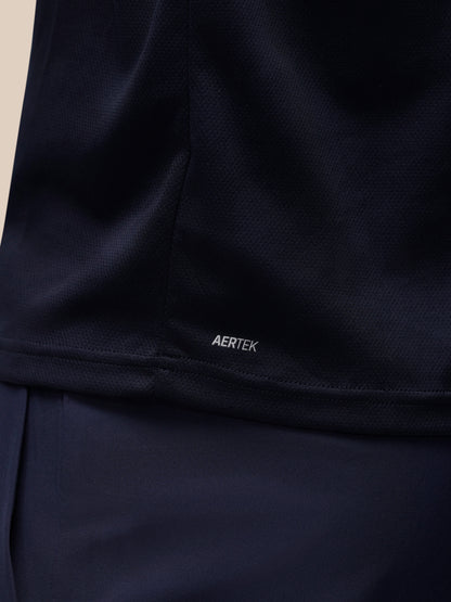 Close-up of a dark navy athletic top showing the AERTEK logo near the hem, with matching navy fabric below.