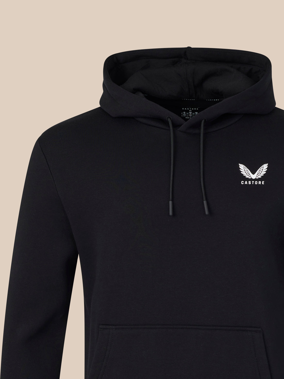 Black hoodie with a logo on a beige background