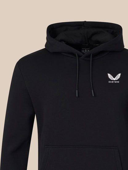 Black hoodie with a logo on a beige background