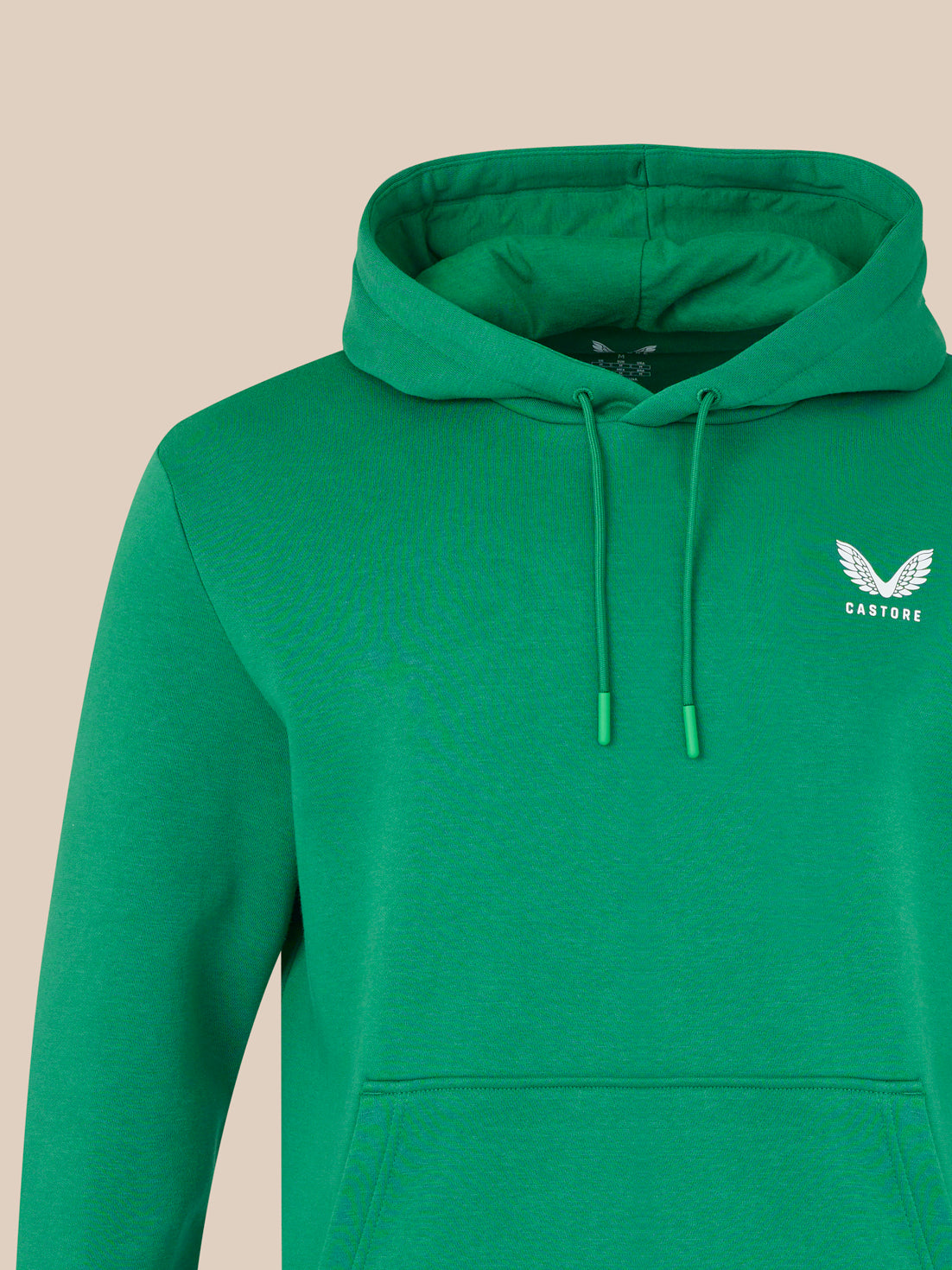 Green hoodie with a logo on a beige background