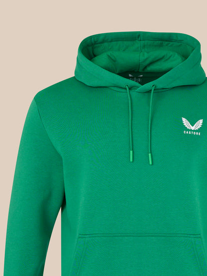 Green hoodie with a logo on a beige background