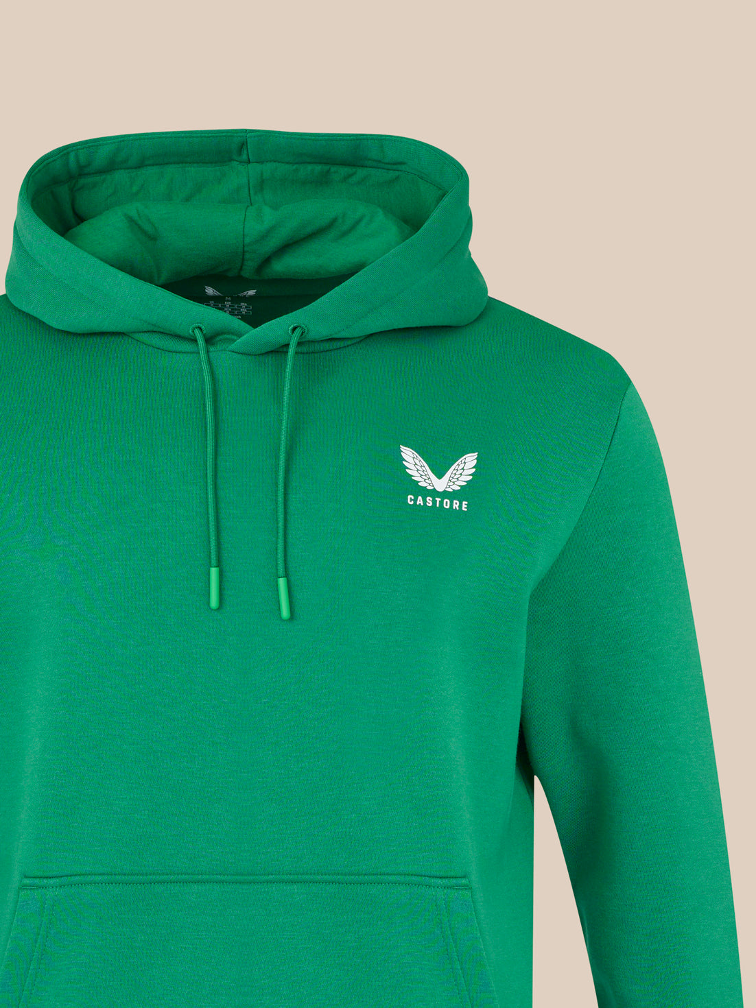 Green hoodie with a logo on a beige background