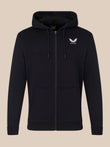 Black hoodie with a logo on the chest against a beige background