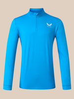 A bright blue long-sleeve quarter-zip athletic pullover with a small white winged logo on the left chest, displayed on a solid beige background.
