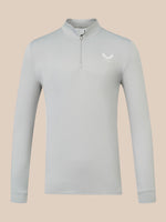A light gray long-sleeve quarter-zip pullover with a small white wing logo on the left chest, displayed on a solid beige background.