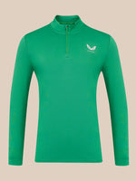 A green long-sleeve quarter-zip pullover with a small white wing logo and the brand name 'Castore' on the left chest, displayed on a solid beige background.