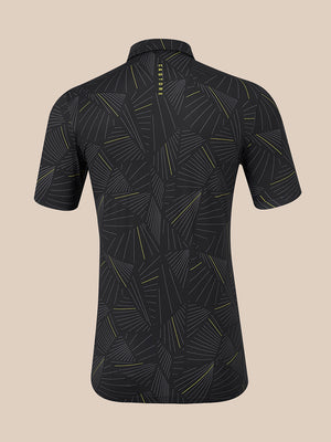 A short-sleeve polo shown from the back, featuring a dark charcoal gray base with a repeating geometric leaf pattern in light gray and thin yellow lines. The brand name 'CASTORE' is printed vertically in yellow near the collar.